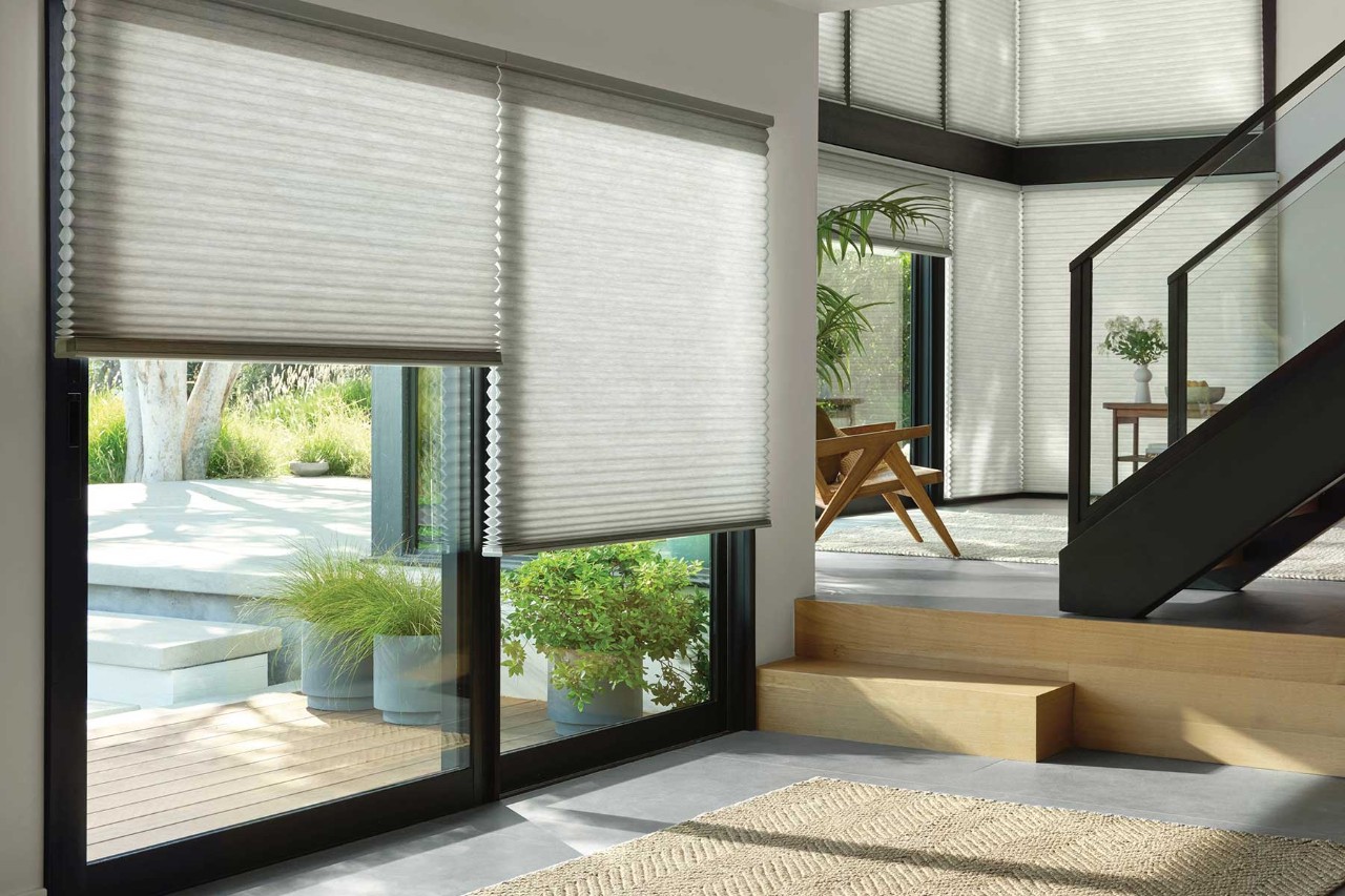 Energy Smart Style Saving Event - white living room with large energy efficient shades in the windows..